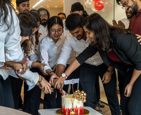 SpazioLiv team cutting a celebration cake